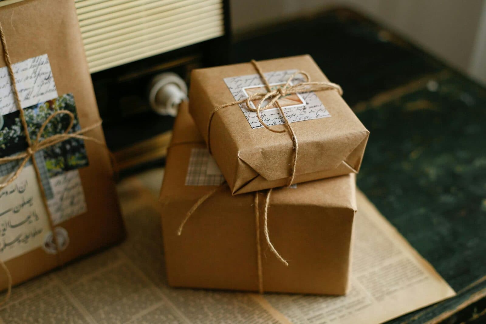 A kraft-wrapped parcel with stamps and string on a kitchen table.